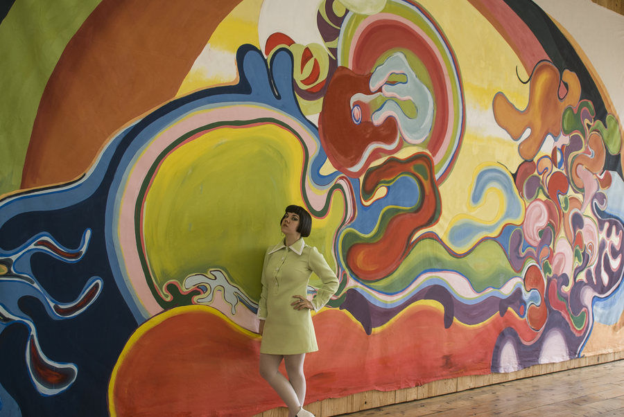 Site-specific installation by Ornella Ruiz Díaz: large-format mural painting on canvas, with the artist in front of the work