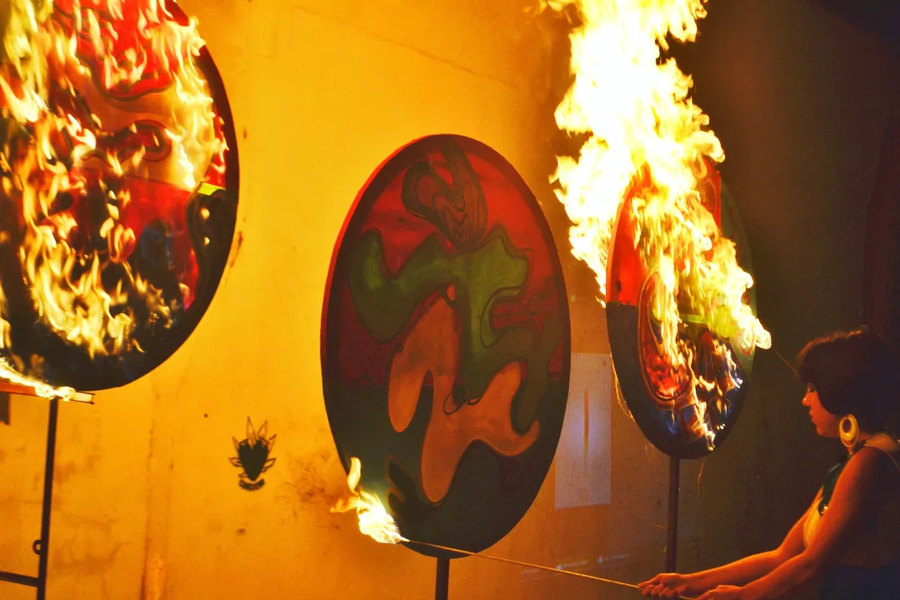 Burn Art Show performance by Ornella Ruiz Díaz: circular paintings on fire during the symbolic burning of the original works