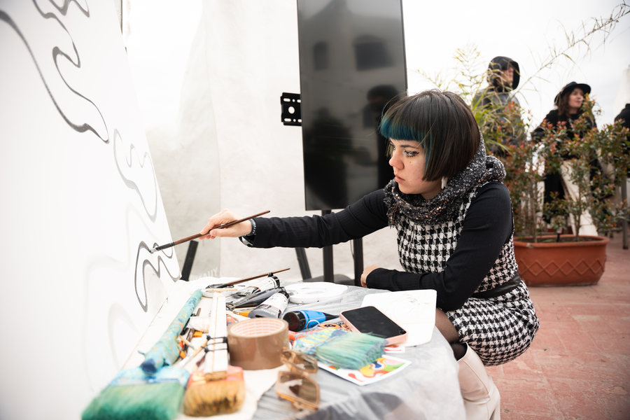 Ornella Ruiz Díaz live painting on a wall at Casapueblo, Uruguay
