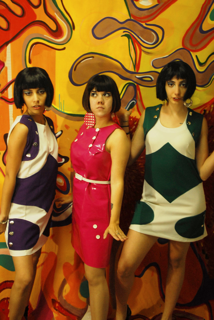 The Ornelettes by Ornella Ruiz Díaz wearing costumes designed by the artist in front of a large-format mural painting